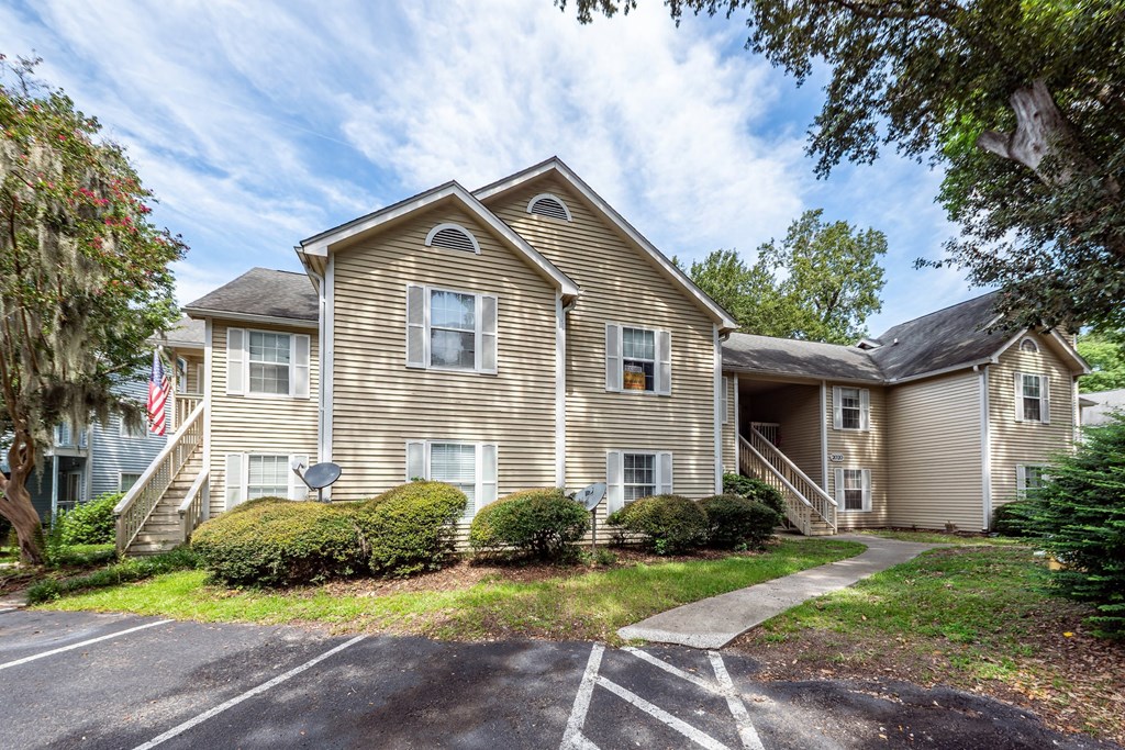 A two-story house with a garage and a driveway.