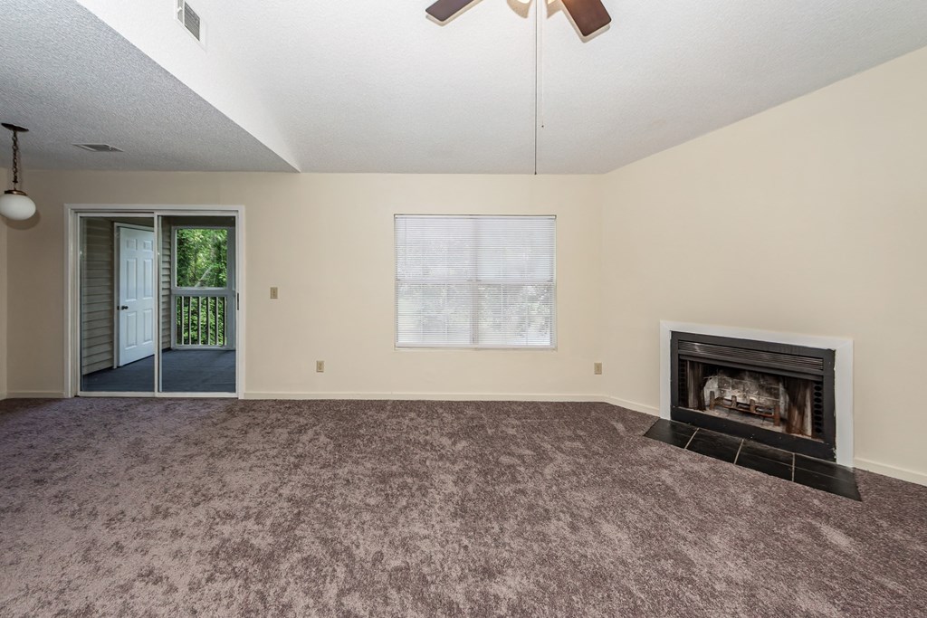 A room with a fireplace and a window.