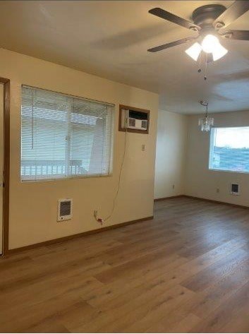 A room with a ceiling fan and a window with blinds.