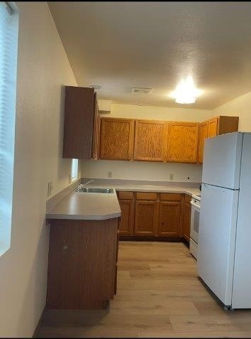 A kitchen with wooden cabinets and a white refrigerator.