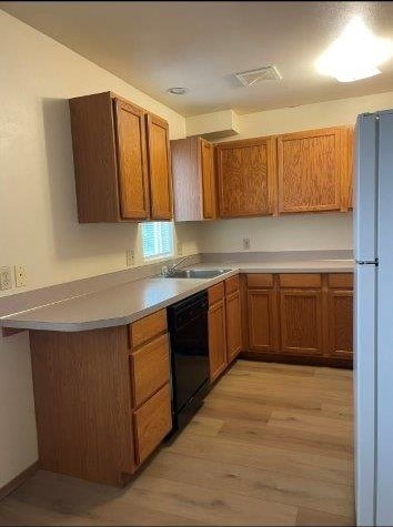 A kitchen with wooden cabinets and a white refrigerator.