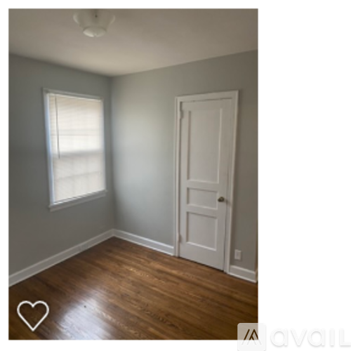 A room with a white door and a window.