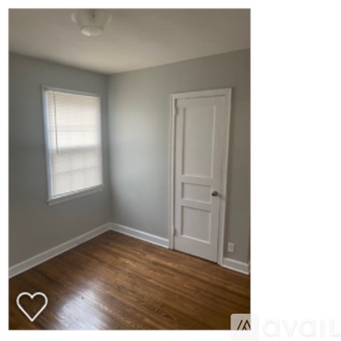 A room with a white door and a window.