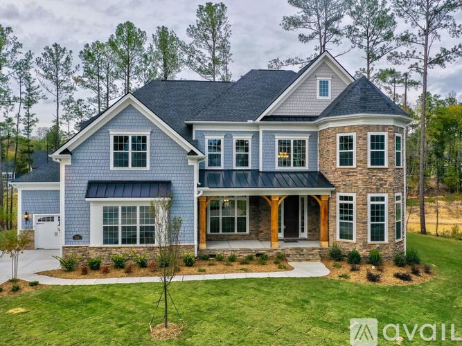 A house with a blue exterior and a large front porch.