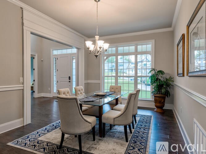 A dining room with a glass table and chairs.