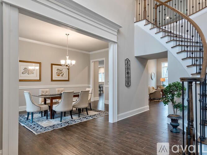 A dining room with a wooden table and chairs.
