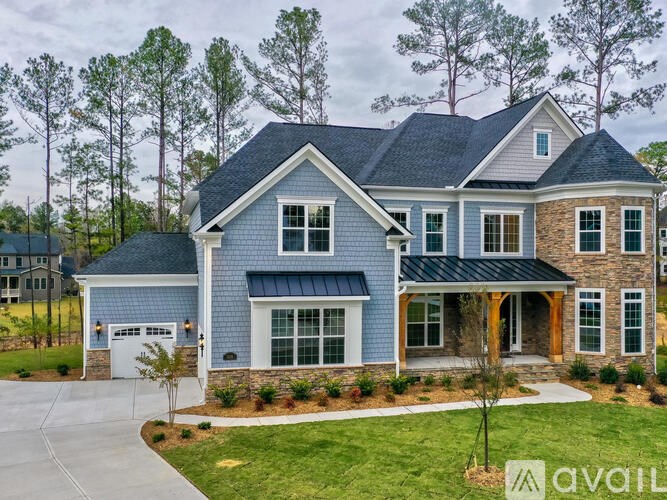 A house with a blue exterior and a garage.