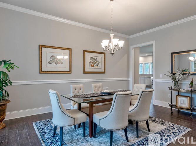 A dining room with a table set for four.