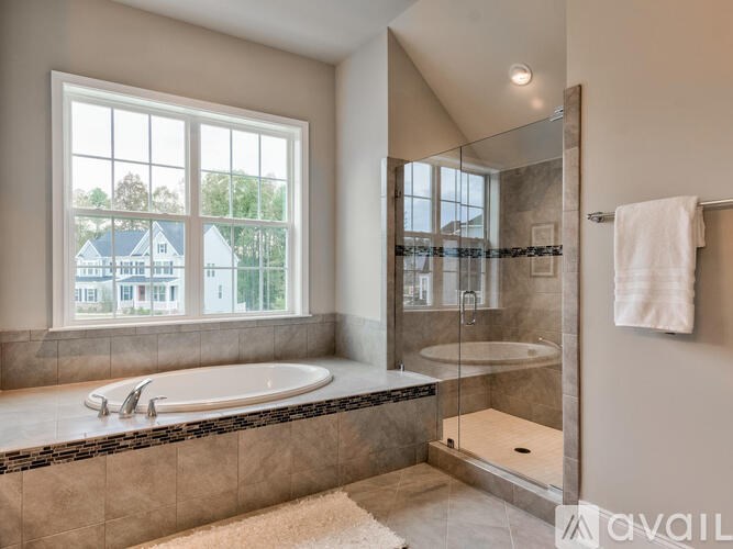 A bathroom with a large tub and a walk-in shower.