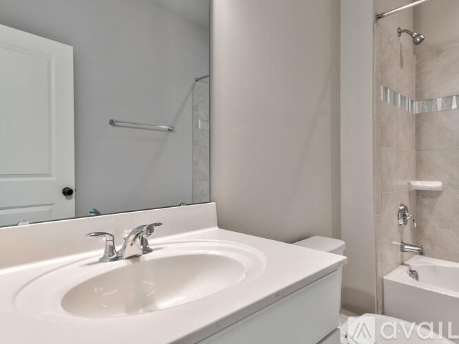A white bathroom sink with a silver faucet.