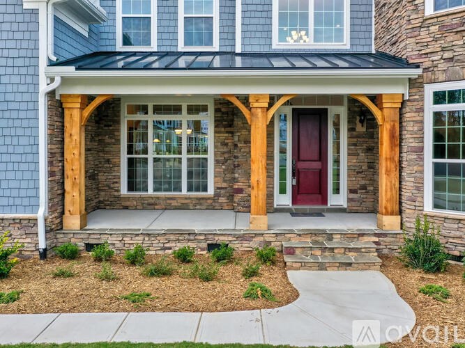 A house with a red door and a covered porch.