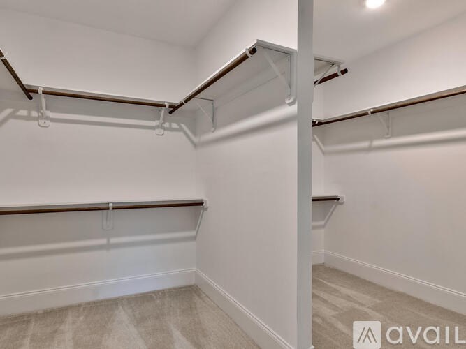 A white wall with a shelf and a white floor with a shelf.