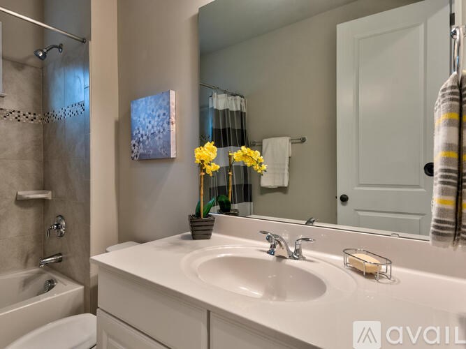 A bathroom with a white sink and a white toilet.