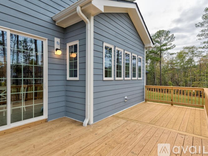 A house with a deck and a balcony.