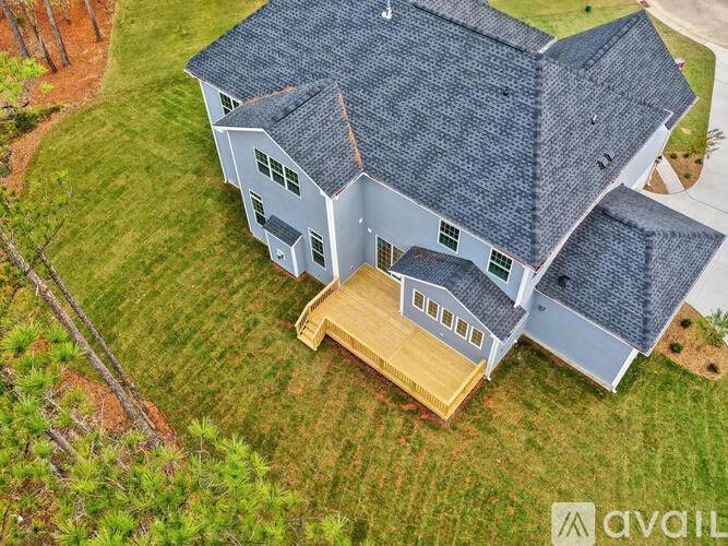 A house with a grey roof and a wooden deck.