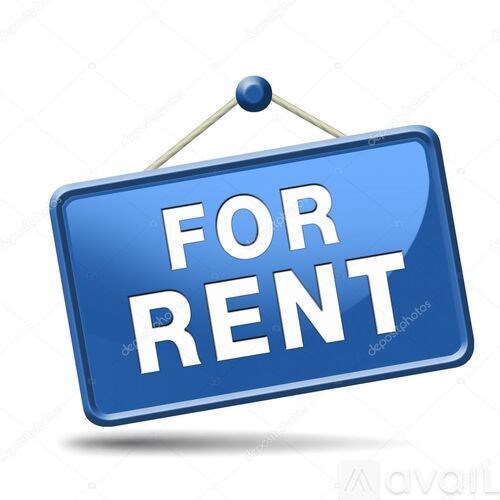 A blue sign with the words "FOR RENT" hanging on a wall.