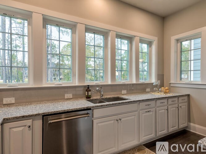 A kitchen with a granite countertop and a sink.