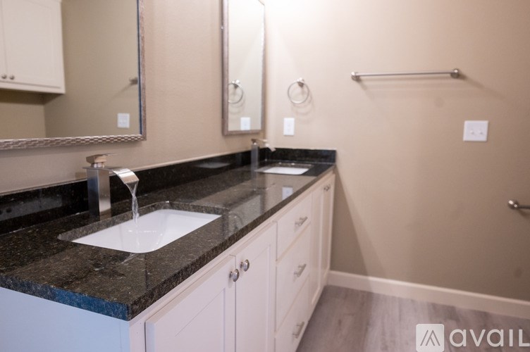 A bathroom with a sink and a mirror.