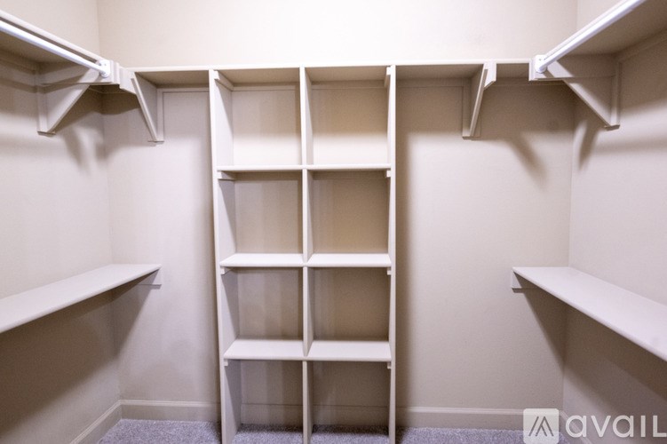 Empty white shelves in a room.