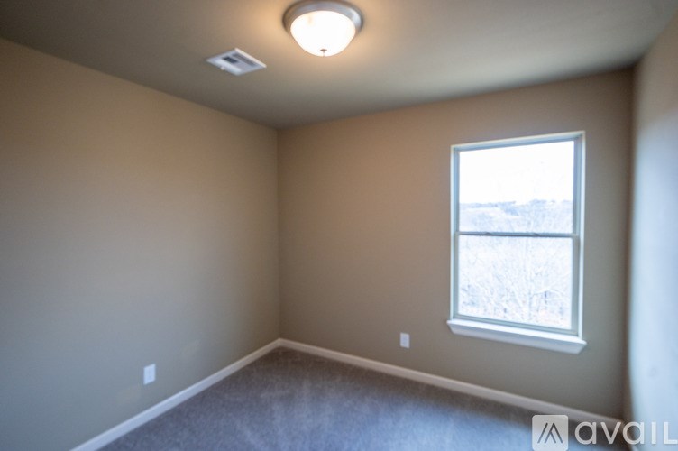 A room with a window and a ceiling light.