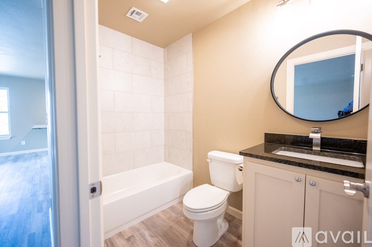 A bathroom with a toilet, sink, and bathtub.