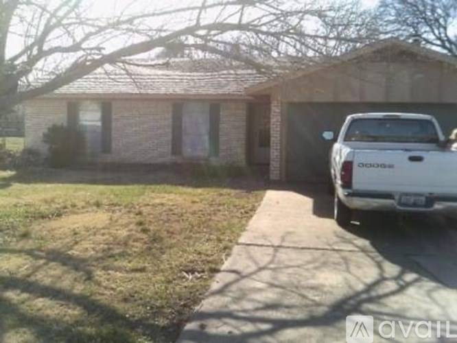 A white pickup truck is parked in front of a house.