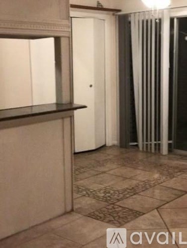 A room with a tiled floor and a curtain.