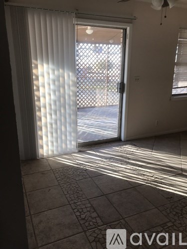 A room with a tiled floor and a ceiling fan.