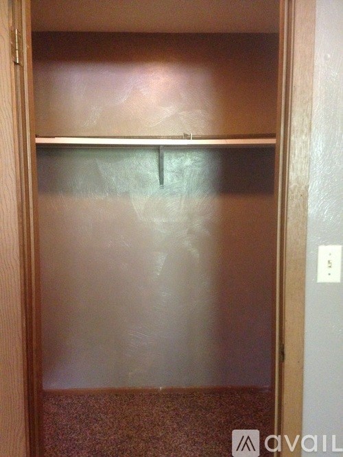 A closed wooden door with a metal handle.