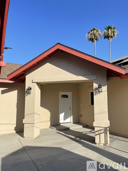 A house with a red roof and a white door is shown.