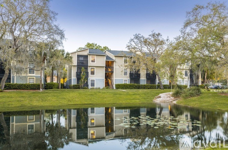 A modern house with a pond in front.