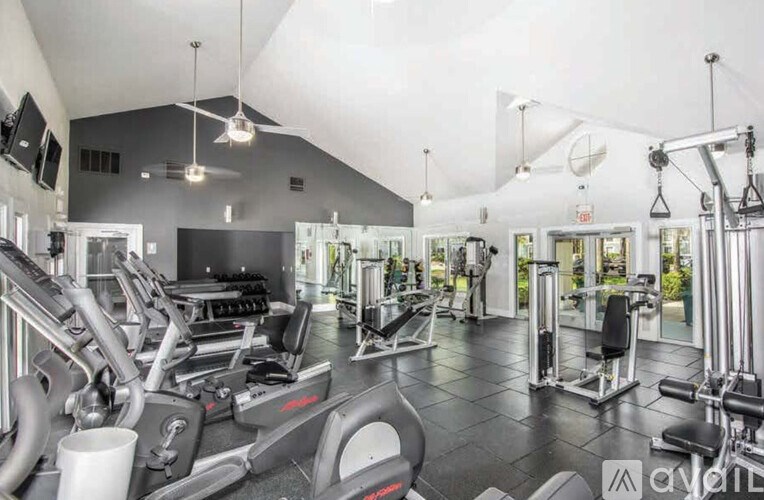 A gym with treadmills, weights, and exercise equipment.
