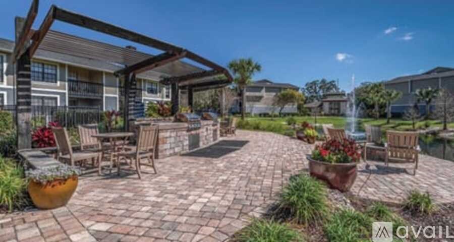 A patio area with a table and chairs surrounded by potted plants.