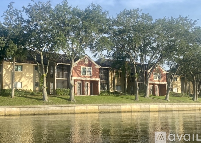 A row of houses with trees in front of them.