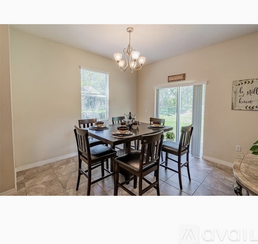 A dining room with a table set for four.