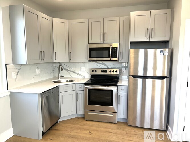 A kitchen with white cabinets and stainless steel appliances.
