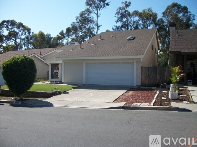 A house with a garage and a driveway in front.