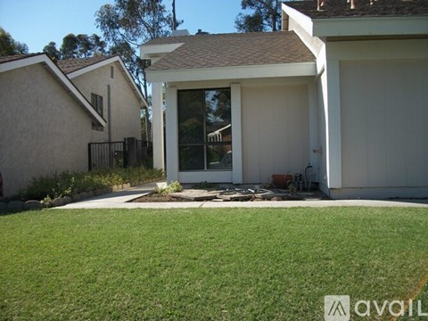 A house with a white garage door and a brown roof.