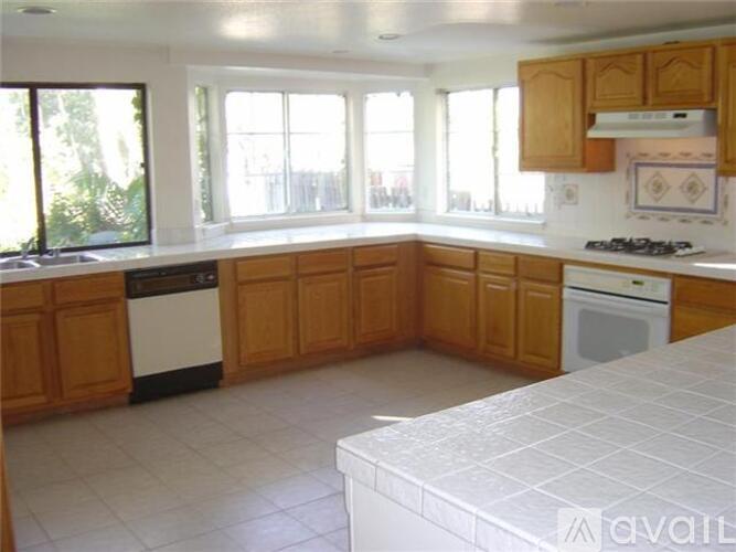 A kitchen with wooden cabinets and white appliances.