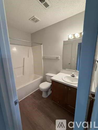 A bathroom with a toilet, sink, and shower.