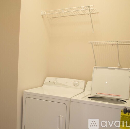 A white washing machine and dryer in a laundry room.