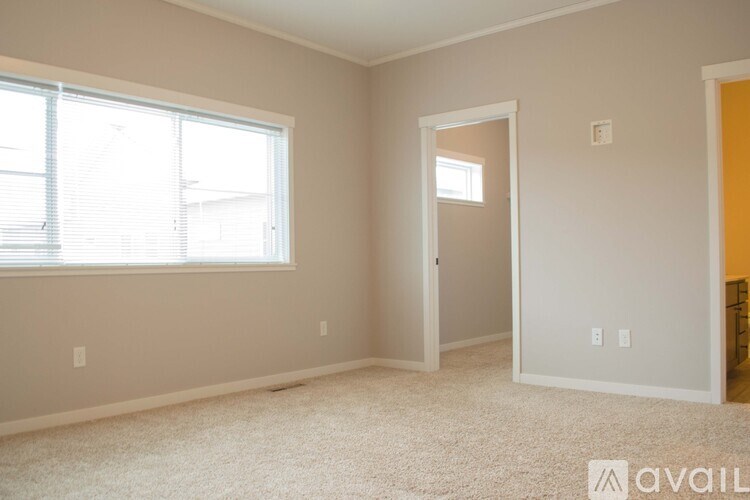 A room with a window and a door is available for rent.