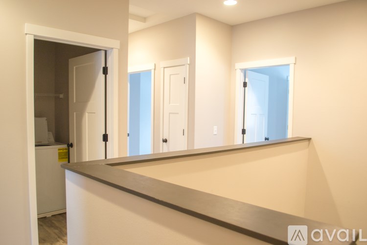 A modern kitchen with white cabinets and a countertop.