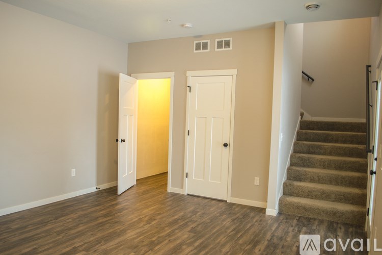A room with a staircase and a door.