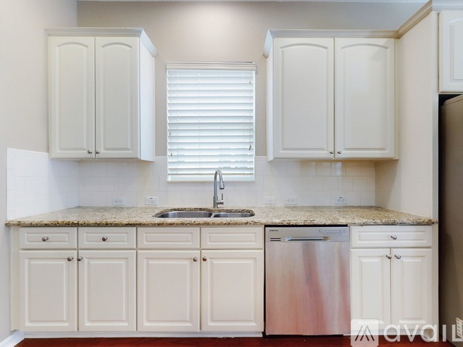 A spacious room with a ceiling fan and tiled flooring.