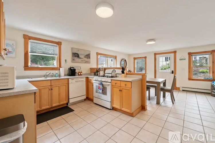 A kitchen with wooden cabinets and white appliances.