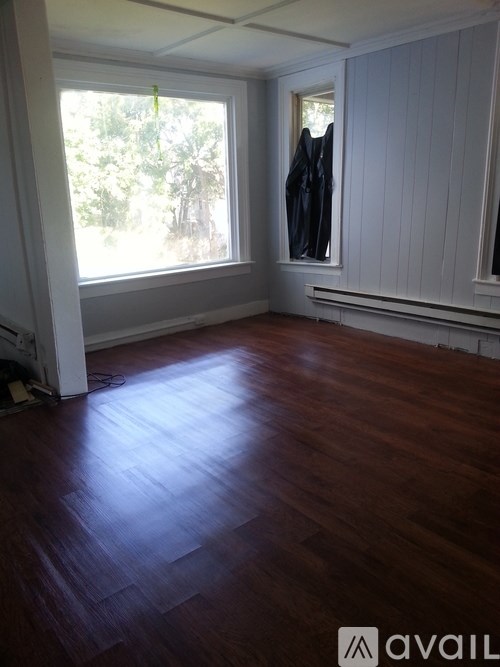 A room with wooden floors and a window.