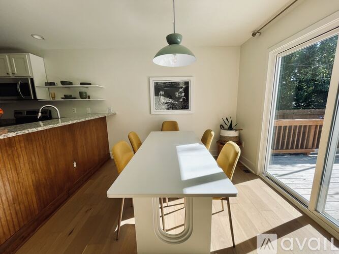 A kitchen with a table and chairs and a window.