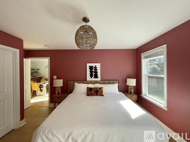 A bedroom with a large bed and a window.