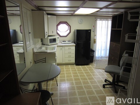 A kitchen with a table and chairs in the middle of the room.